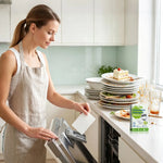 Eco Dishwasher Sheets beside dishes ready for hand washing at a kitchen sink