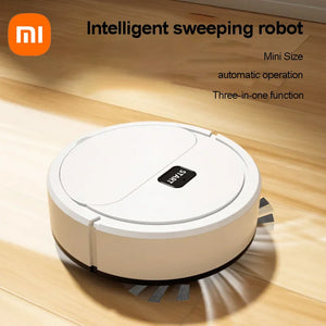 Xiaomi Smart Sweeping Robot Vacuum cleaning a hardwood floor, showcasing its 3-in-1 functionality to vacuum, sweep, and mop. This compact, rechargeable robot vacuum effortlessly navigates tight spaces, tackles pet hair, dust, and spills, and offers fully automatic operation—perfect for busy households and multi-surface cleaning.