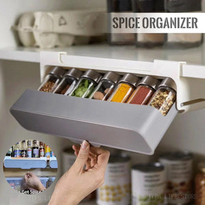 Wall-mounted under-shelf spice rack with pull-out compartment for organizing up to seven spice jars, featuring durable food-grade materials and drill-free 3M adhesive installation for modern kitchens.